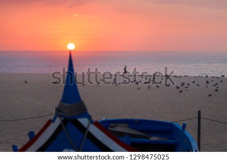 Man walks along the sand on the ocean at sunset. Sunset on the bow of the boat.