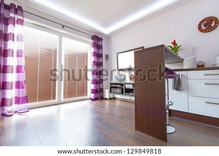 Modern white living room interior with purple curtains