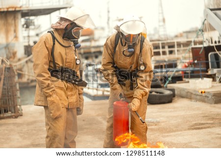 Firefighters seaman on a ship in undeveloped countries use teamwork on a training how to stop fire in a dangerous mission and protect the environment