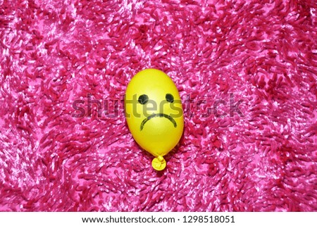 Yellow Ballon Emoticon With A Pink Background