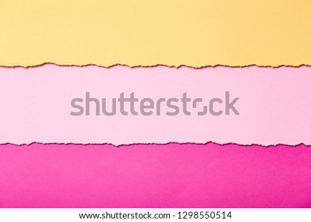 abstract background of multi-colored stripes of torn cardboard lying horizontally, top view,concept stationery business