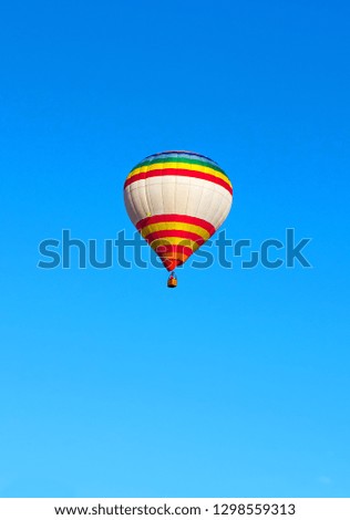 Beautiful multi-colored flying balloon. against the blue sky. Type of rest. Hobby.
