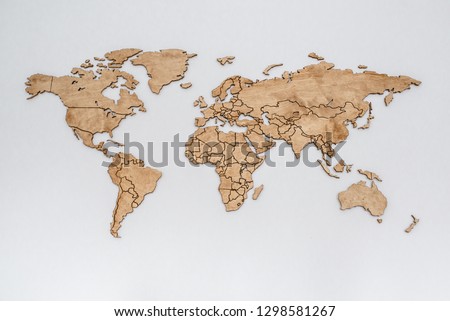 Wooden world map on a white wall. Geography concept. Background for travel. Logistics and transportation, worldwide business. All continent. Europe, America, Africa, Australia and Asia
