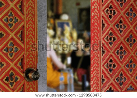 European woman sitting in front of the monk to talk and pray in Thailand.