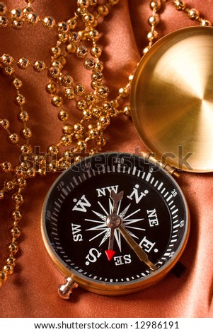 Compass and jewelry still life