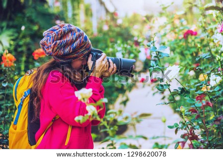 woman travel nature taking photographs in the rose garden at doi Inthanon Chiangmai in Thailand.