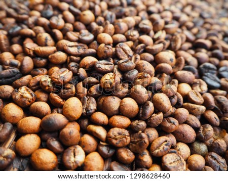 Roasted coffee beans on a tray.