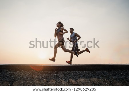 Young couple running on the street be running for exercise. fitness, sport, people, exercising ,running and lifestyle concept . Royalty-Free Stock Photo #1298629285