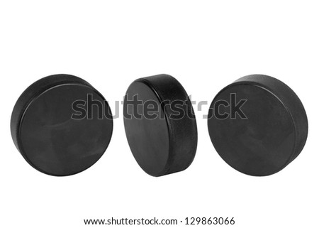 Hockey pucks, lined up in a row on a white background