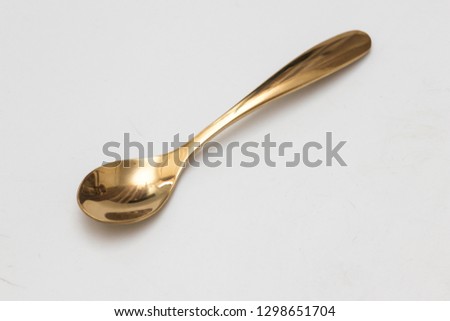 Golden spoon isolated white background