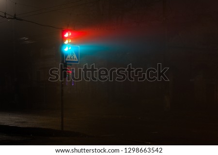 Traffic light in night in fog