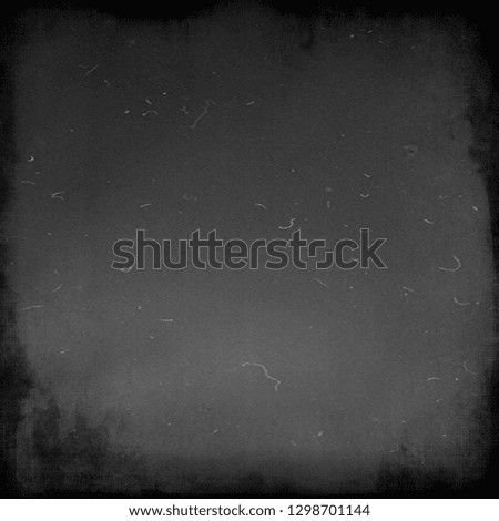 Grey grunge scratched scary background with black frame, old film effect, dusty texture
