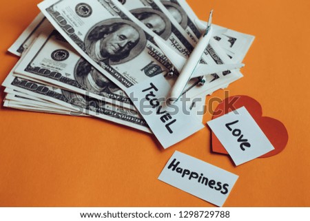 Money, travel, love and happiness, happiness depends on money, love, and travel concept. Airplane on dollars.