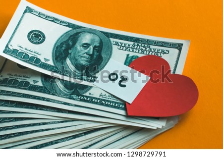 Money or Love concept, Love depends on Money, money on isolated orange background 