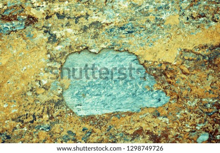 Stone texture.
Yellow, orange and red spots of stone outgrowth on a gray-blue marble background. Stone background, copy space.