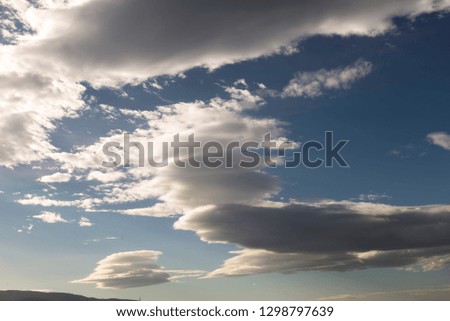 Cumulus clouds on a blue sky background.