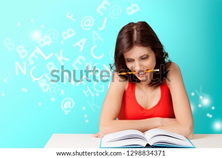 Young female college student and stack book on table at library background