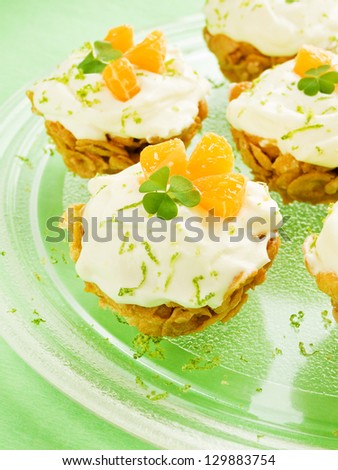 Cereal cupcakes with tangerine and tiramisu cream. Shallow dof.