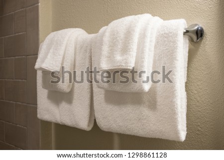 Clean white towel on a hanger prepared to use.