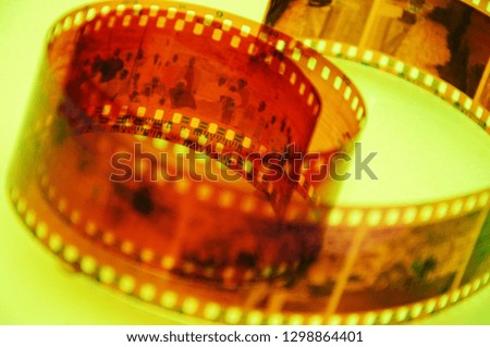 color film with a negative, on a yellow background. blurred front background
