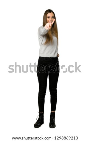 Full-length shot of young girl showing and lifting a finger on isolated white background