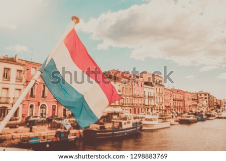 vintage colored picture of france flag at small river at setÃ©