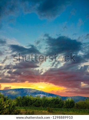 Beautiful sunset sky in yellowish and blue tones over mountains
