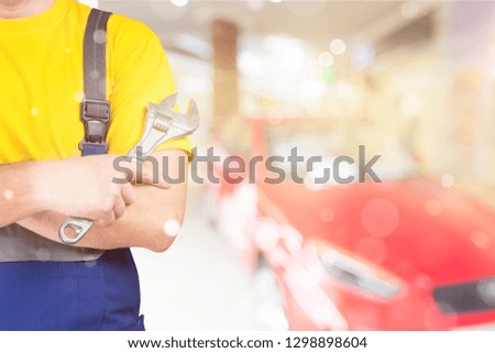 Worker holding wrench in hand on background,close up