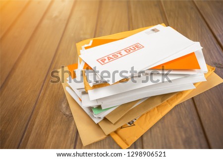 Pile of envelopes with overdue utility bills isolated on white Royalty-Free Stock Photo #1298906521