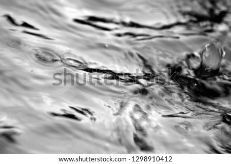 Abstract raindrops in the fishing pond. De focused. Black and white style.