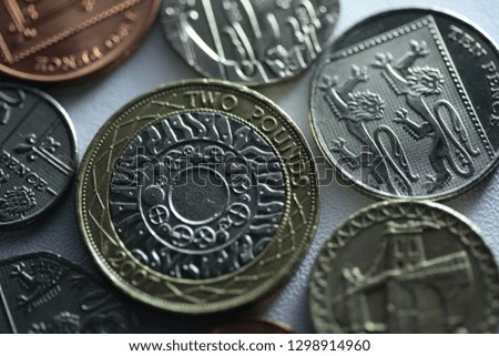 A close up of uk coins. Royalty-Free Stock Photo #1298914960