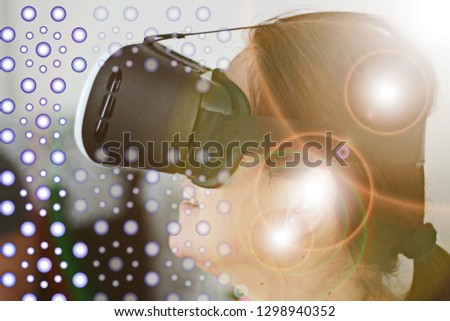 Happy woman getting experience using VR headset glasses of virtual reality at home- Image