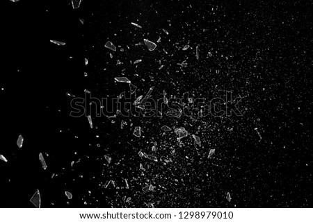 Exploding glass of fine shards and pieces Royalty-Free Stock Photo #1298979010