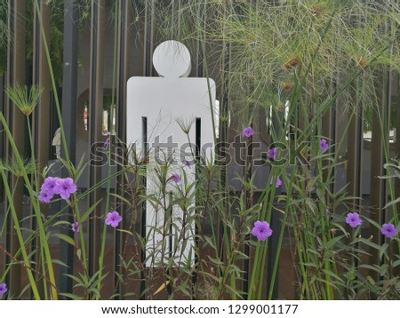 design White Man toilet sign on nature of purple flowers