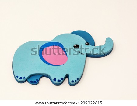 Wooden toy blue elephant on white background