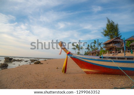 Boat, boats on the beach in front of wide orange colorful sunset in Thailand Ko Lanta Isaland Beach, sun, sea, stones, sky, clouds, water, sand, ocean, palms