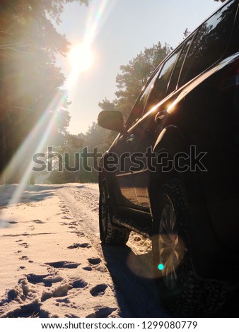 car on winter road in the morning. Vertical picture