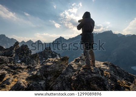 A man take picture of Himalaya mountains on top of Gokyo Ri in Everest base camp trek, Nepal, Asia