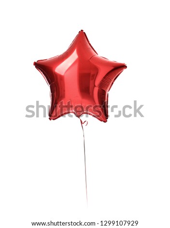 Big red metallic latex star balloon for birthday party isolated on a white background
