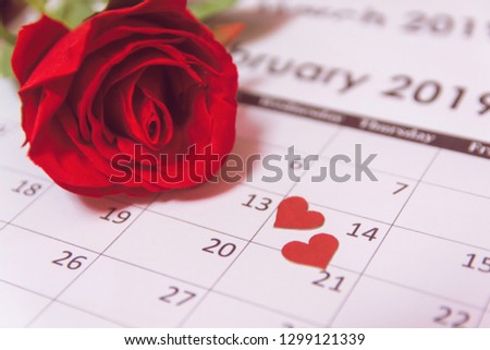 Valentines day. Red rose and red hearts on Calendar page February 14 with copy space