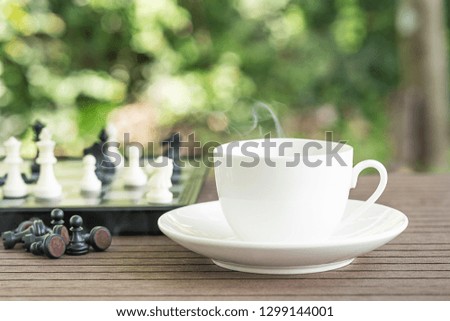 Cups of coffee on table with Chess board and pieces for relax time