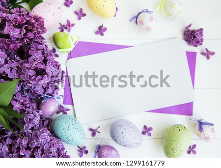 Easter greeting card with eggs and lilac flowers