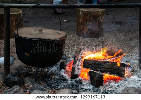 Pot on fire. kettle with water or tea on a fire, tourists a kettle on a fire. Camping photo