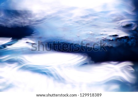 Waves and twists. macro shot of blue liquid soap and water