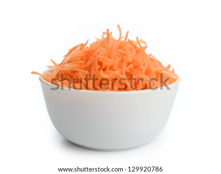 Grated carrots in a white cup isolated on a white background