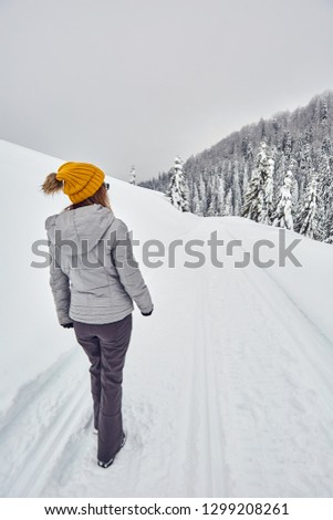 Hapopy tourist lady in her winter holiday in the mountains