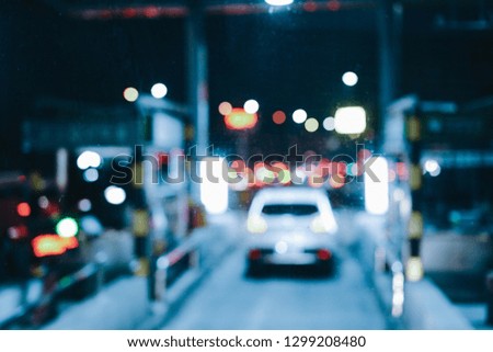 Blur focused urban abstract texture bokeh city lights & traffic jams. Looking out from the windshield of the car cab.