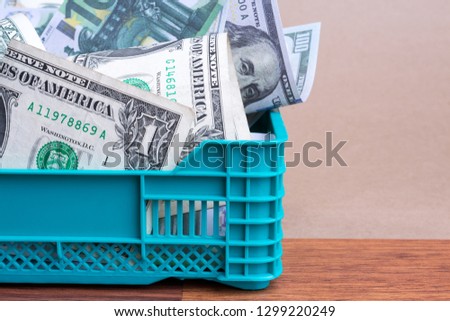 stack of money in basket