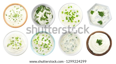 Set of delicious sour cream with herbs in bowls on white background, top view Royalty-Free Stock Photo #1299224299