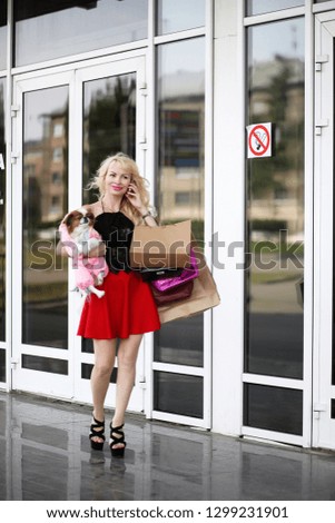 Beautiful young blonde on a walk with little dog